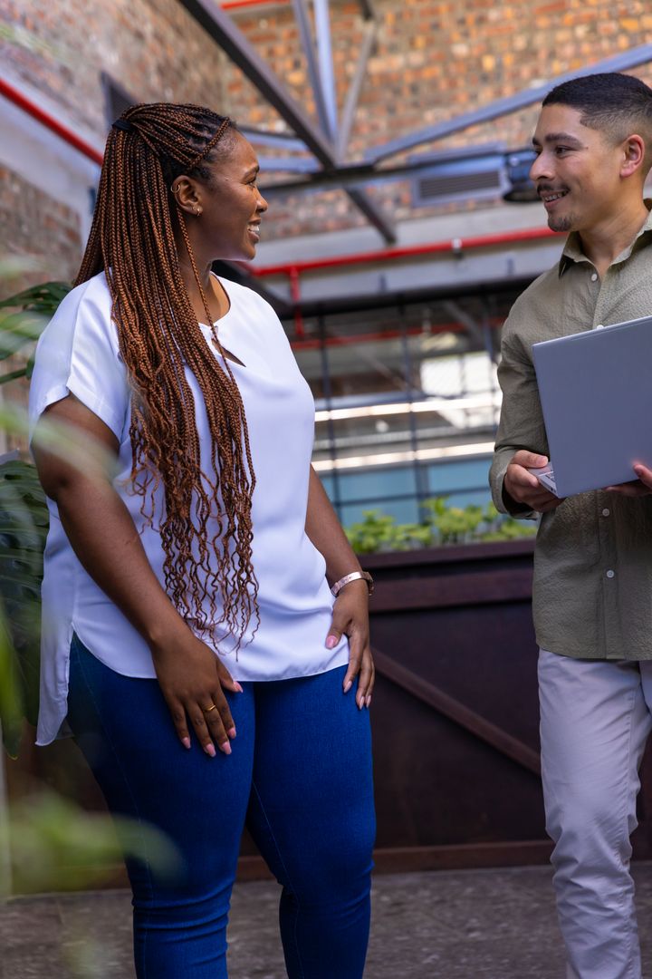Diverse Colleagues Discussing Project in Office Courtyard