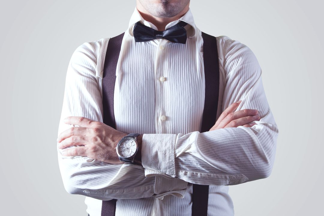 Confident Man Wearing Formal Attire with Bow Tie and Suspenders - Free Images, Stock Photos and Pictures on Pikwizard.com