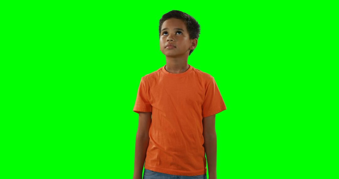 Child Looking Up in Orange Shirt with Green Screen Background - Free Images, Stock Photos and Pictures on Pikwizard.com