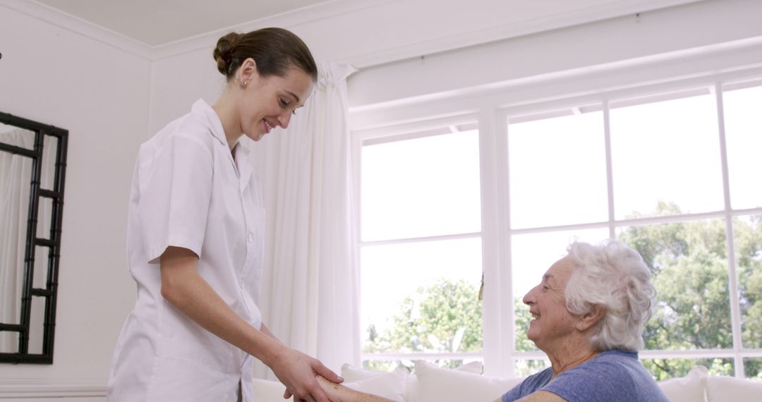 Friendly Caregiver Attending to Elderly Woman at Home - Free Images, Stock Photos and Pictures on Pikwizard.com