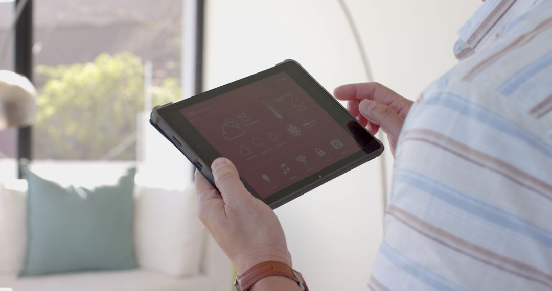 Senior Man Using Tablet in Modern Sunny Living Room