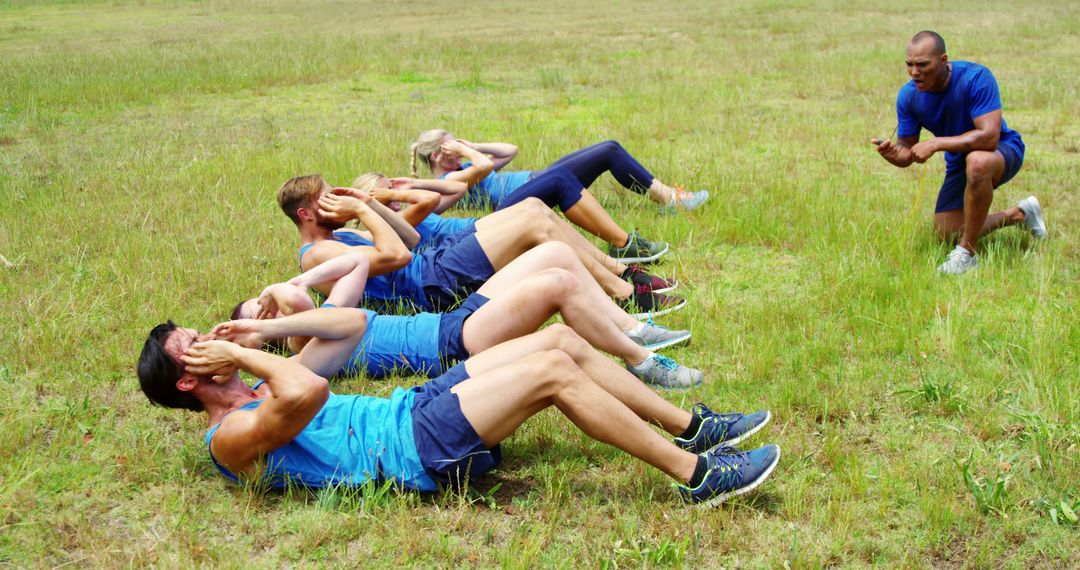 Fitness Coach Leading Group Workout in Outdoor Field - Free Images, Stock Photos and Pictures on Pikwizard.com