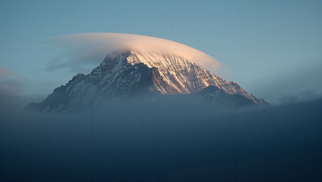 Snow-Capped Peak Catching Light Above Alpine Fog with Lenticular Cloud, Minimalist Sunrise