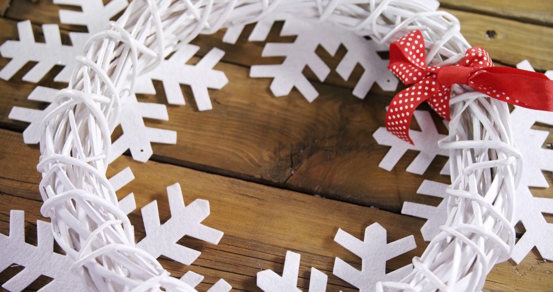 White Christmas Wreath with Red Bow on Wooden Background - Free Images, Stock Photos and Pictures on Pikwizard.com