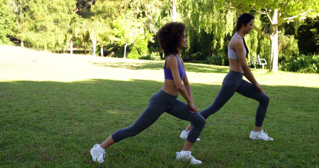 Two Women Stretching in Park During Morning Workout - Free Images, Stock Photos and Pictures on Pikwizard.com