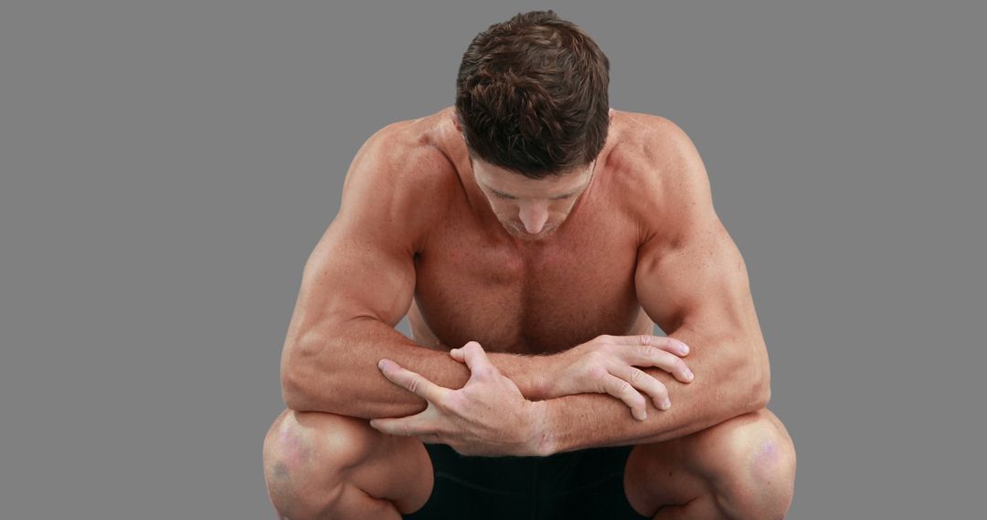 Muscular Man Resting After Workout Against Gray Background - Free Images, Stock Photos and Pictures on Pikwizard.com