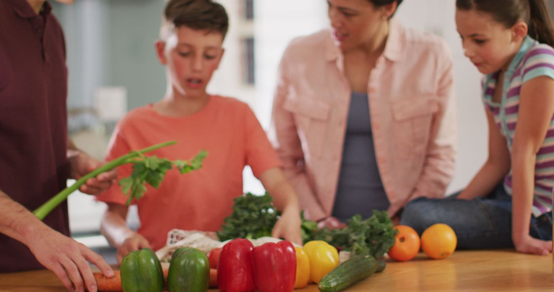 Family Preparing Vegetables Together in Kitchen - Free Images, Stock Photos and Pictures on Pikwizard.com