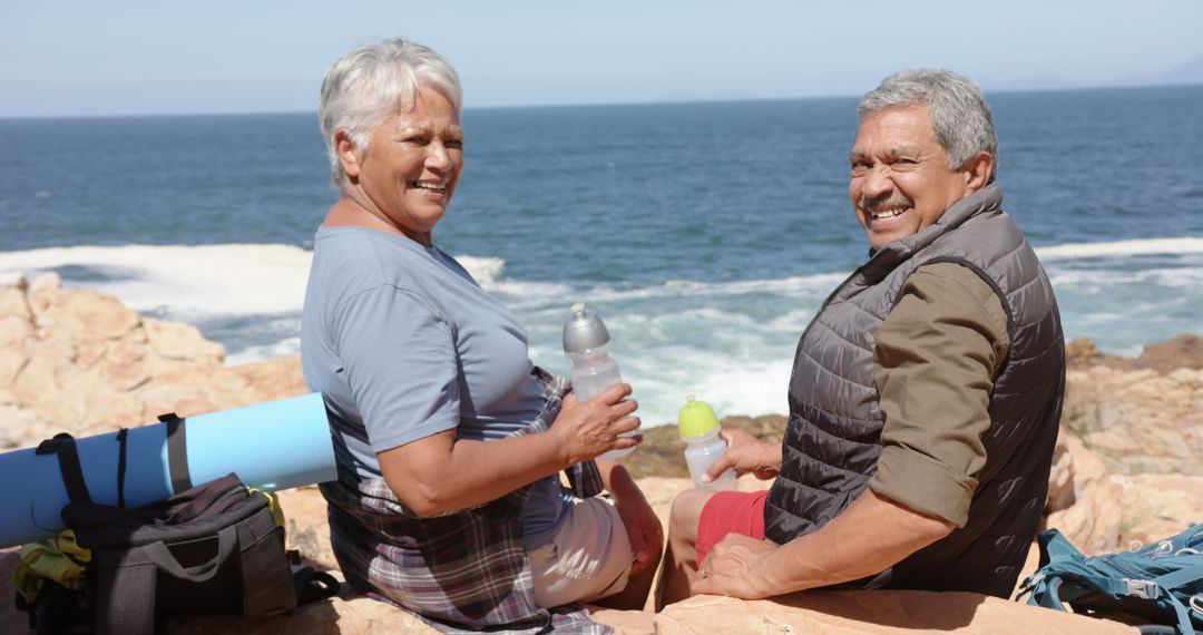 Senior Couple Enjoying a Beachside Outing with Refreshments - Free Images, Stock Photos and Pictures on Pikwizard.com