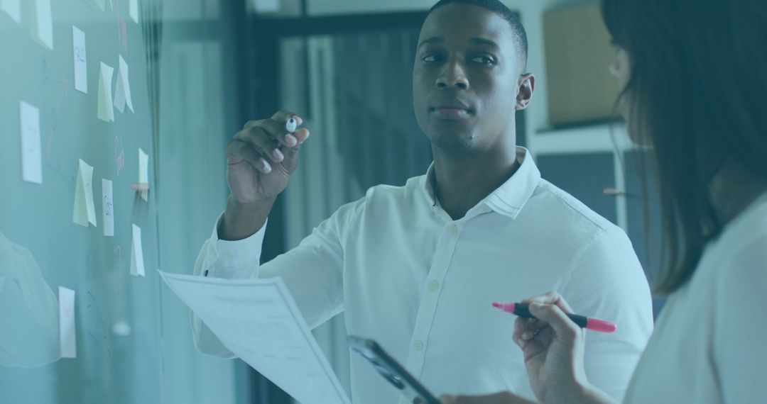 Colleagues Collaborating on Graphs Discuss Data Analysis