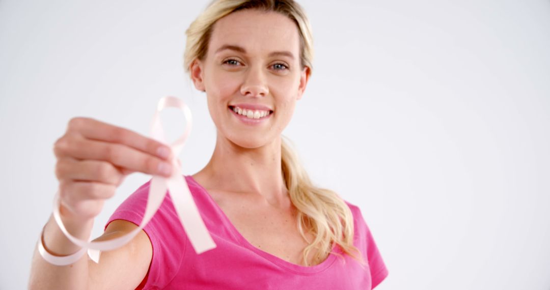 Smiling Woman Holding Pink Ribbon for Breast Cancer Awareness - Free Images, Stock Photos and Pictures on Pikwizard.com