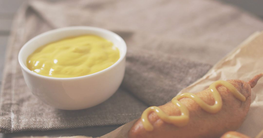 Corn Dog on Stick with Mustard Dip on Rustic Napkin Serving Classic Fair Snack