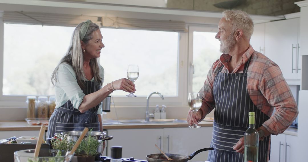 Senior Couple Cooking Together with Wine in Modern Kitchen - Free Images, Stock Photos and Pictures on Pikwizard.com