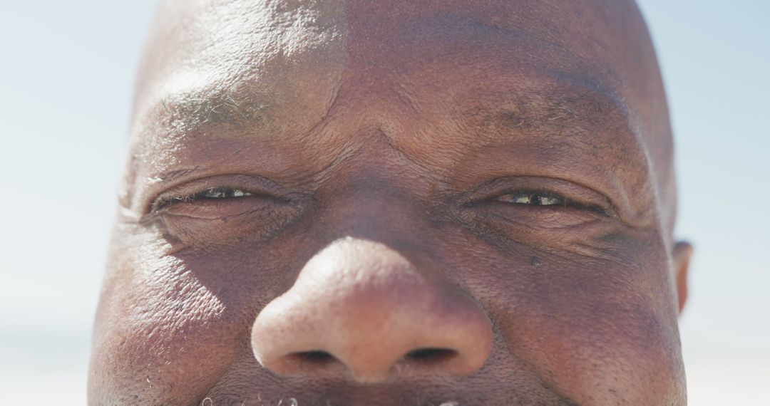 Close-Up Face of Senior African American Man on Beach - Free Images, Stock Photos and Pictures on Pikwizard.com