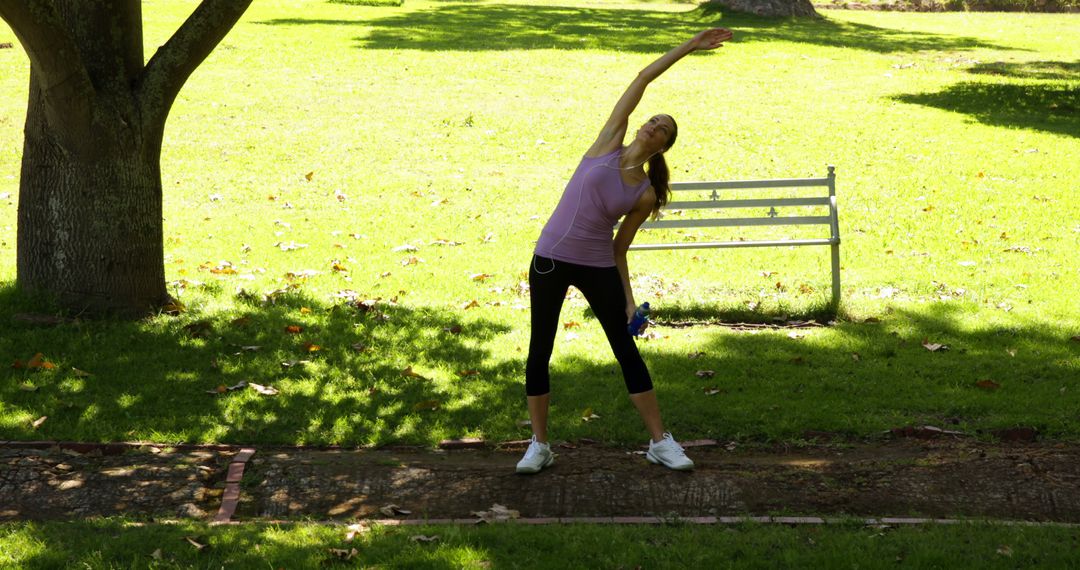 Woman Exercising in Park with Stretching Amidst Greenery - Free Images, Stock Photos and Pictures on Pikwizard.com