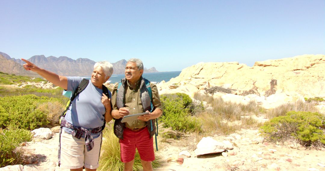 Senior couple hiking in scenic mountain landscape on a sunny day - Free Images, Stock Photos and Pictures on Pikwizard.com