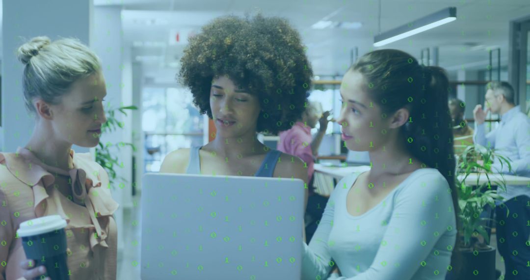 Diverse Businesswomen Collaborating with Technology in Modern Office