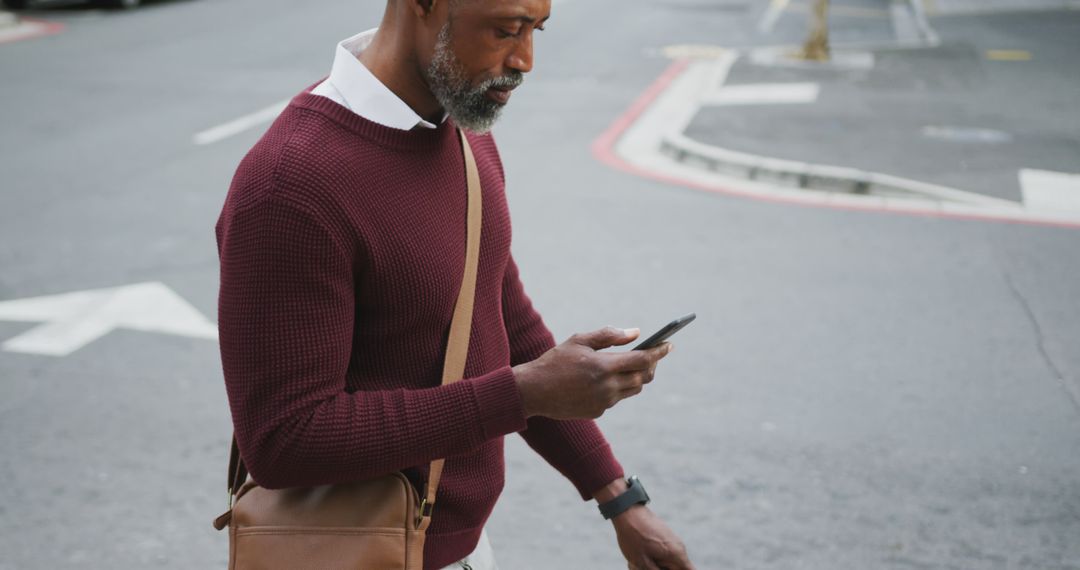 Man Walking on Street Using Smartphone - Free Images, Stock Photos and Pictures on Pikwizard.com