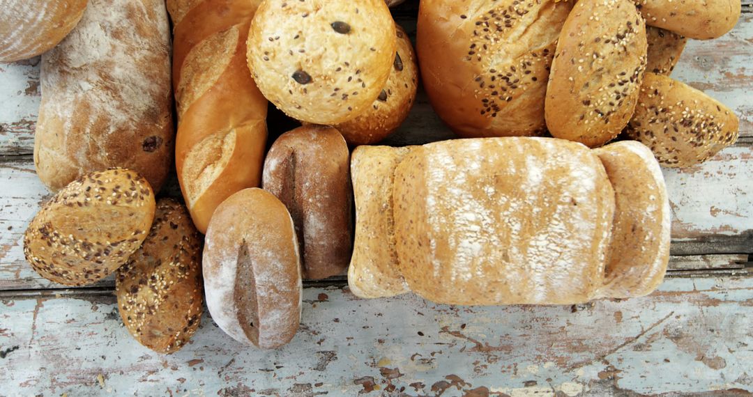 Assorted Fresh Bakery Breads on Rustic Wooden Table