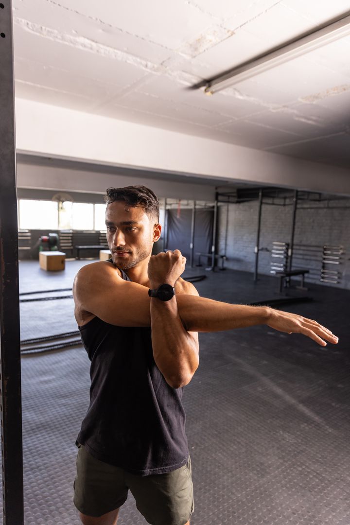Confident Athlete Stretching at Gym Enhancing Flexibility