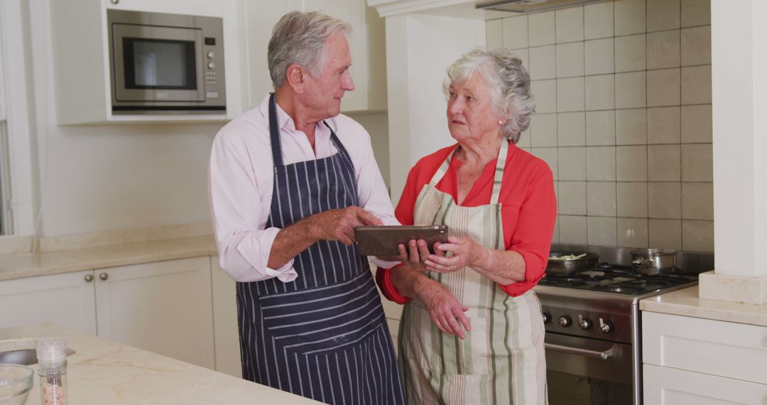 Elderly Couple Baking Together in Kitchen, Sharing Romantic Moments - Free Images, Stock Photos and Pictures on Pikwizard.com