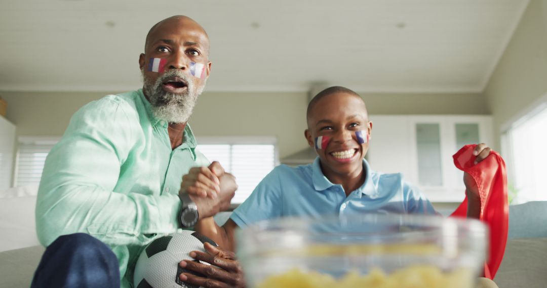 Father and Son Celebrating Victory Watching Soccer Game - Free Images, Stock Photos and Pictures on Pikwizard.com