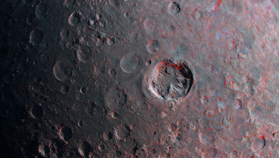 Lunar Crater with Raised Rim and Impact Marks on Moon Surface