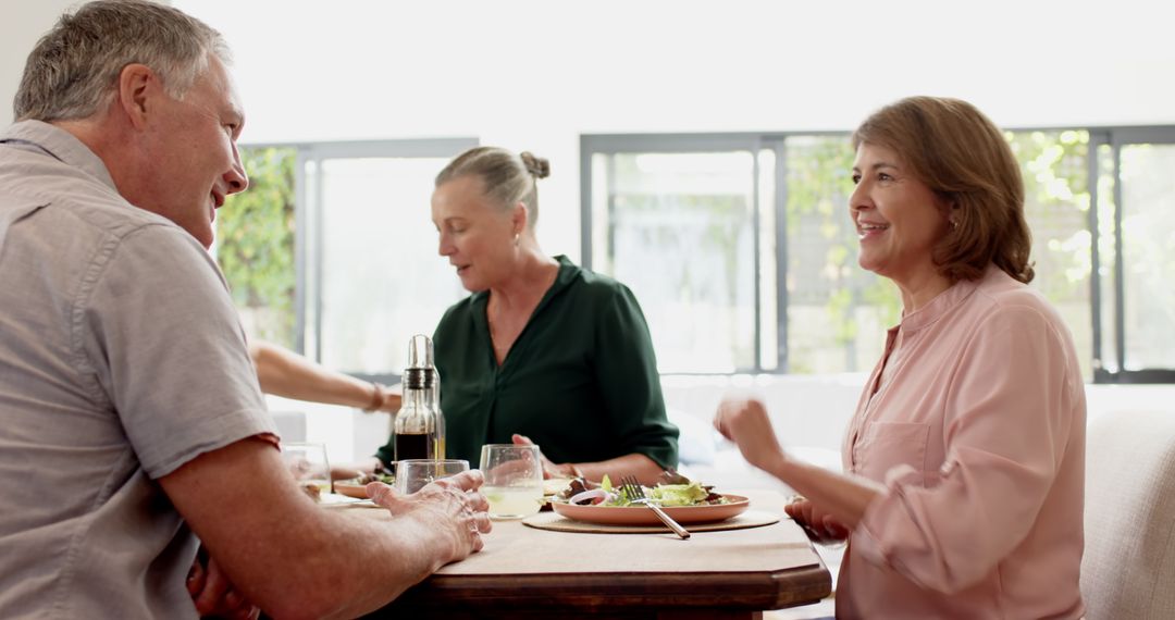 Diverse Friends Enjoying Meal and Conversation at Cozy Dining Table