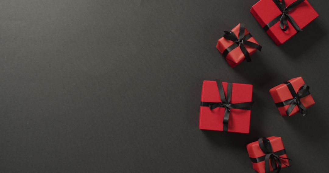 Red Gift Boxes with Black Ribbons on Black Background - Free Images, Stock Photos and Pictures on Pikwizard.com