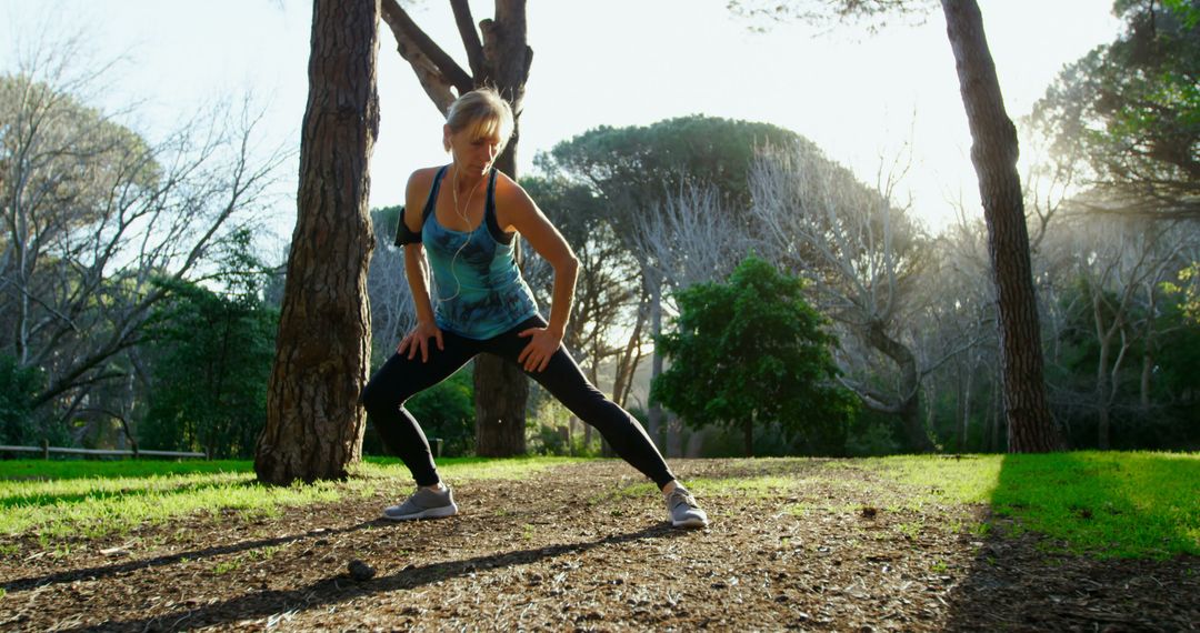 Woman Stretching in Forest Park during Morning Workout - Free Images, Stock Photos and Pictures on Pikwizard.com