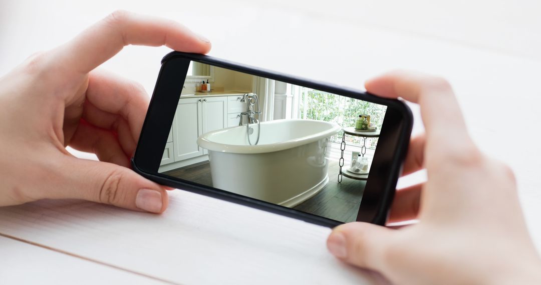 Woman Viewing Modern Bathroom Interior on Smartphone Screen