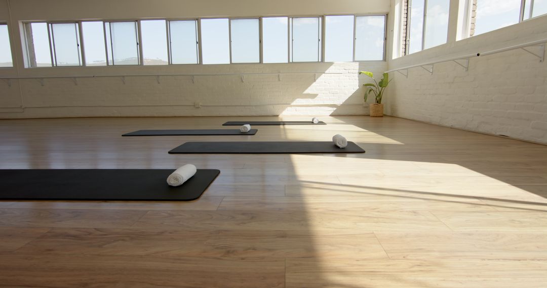 Sunlit Yoga Studio with Prepared Mats for Relaxation