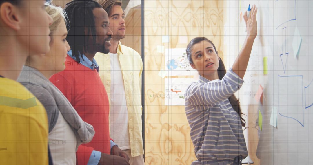 Team Collaborating Around Office Whiteboard for Brainstorming Session