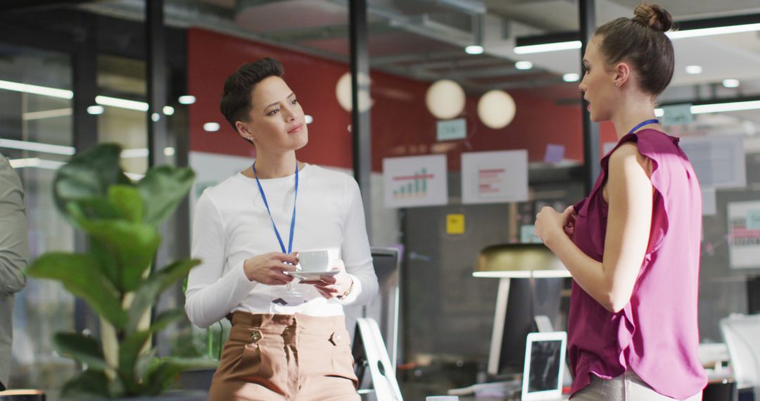 Colleagues Engaging in Conversation at Modern Office Workspace