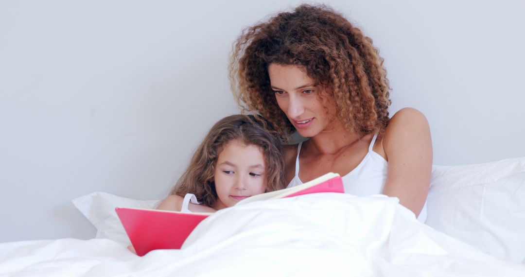 Mother and Daughter Reading a Book Together on Bed - Free Images, Stock Photos and Pictures on Pikwizard.com