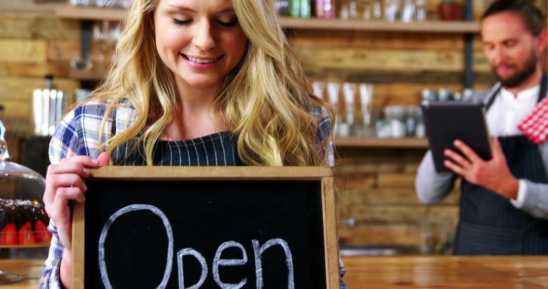 Smiling Female Cafe Owner Holding Open Sign - Free Images, Stock Photos and Pictures on Pikwizard.com