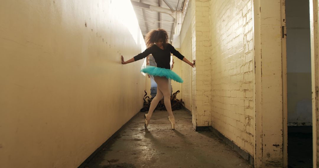 Ballerina Dancing in an Industrial Building Corridor - Free Images, Stock Photos and Pictures on Pikwizard.com