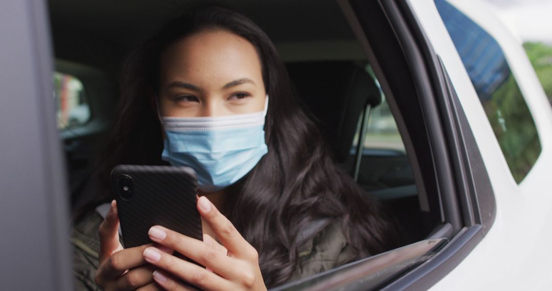 Woman Wearing Mask Using Smartphone in Car - Free Images, Stock Photos and Pictures on Pikwizard.com