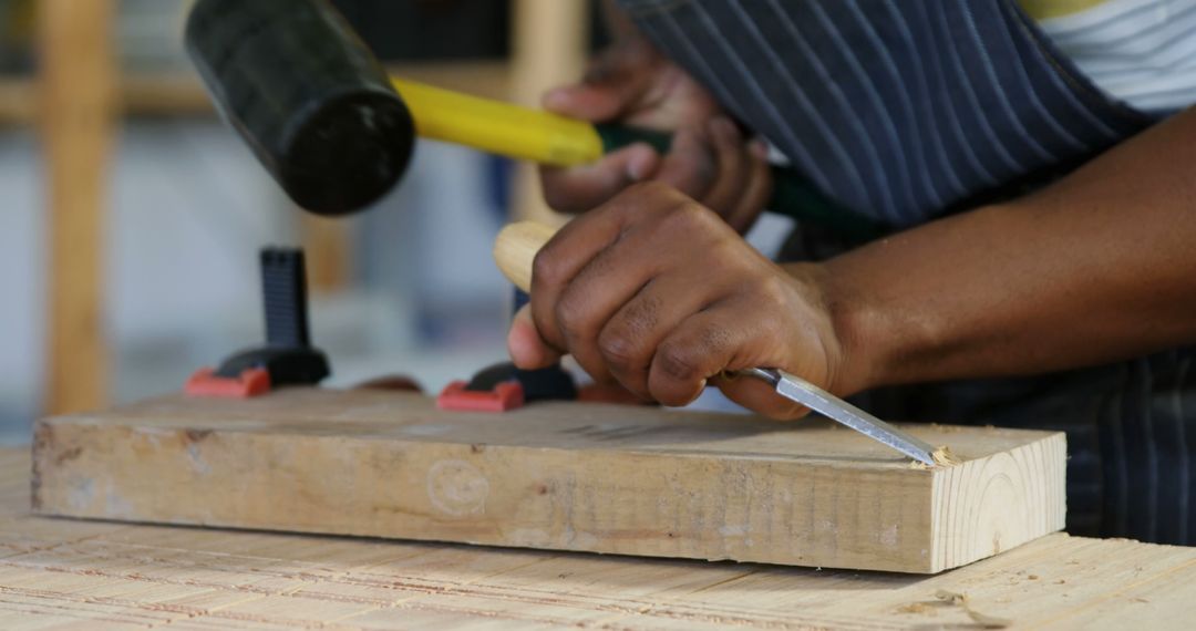 Close-up of Carpenter Carving Wood with Chisel and Hammer - Free Images, Stock Photos and Pictures on Pikwizard.com