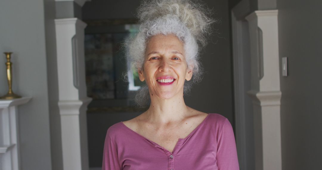 Happy Elderly Woman with White Curly Hair and Pink Shirt at Home - Free Images, Stock Photos and Pictures on Pikwizard.com