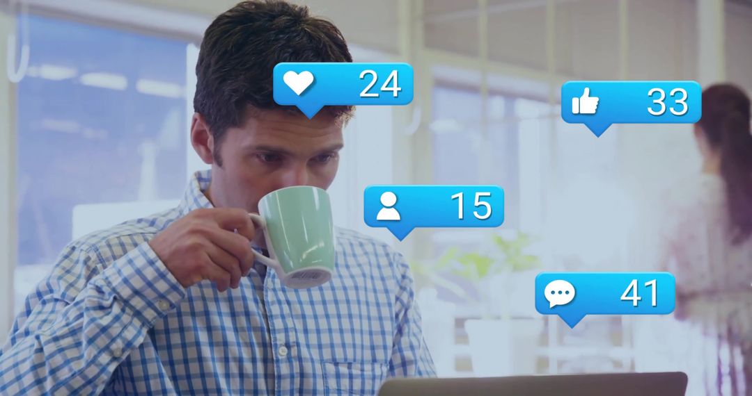 Man Engaged with Digital Notifications While Working in Office