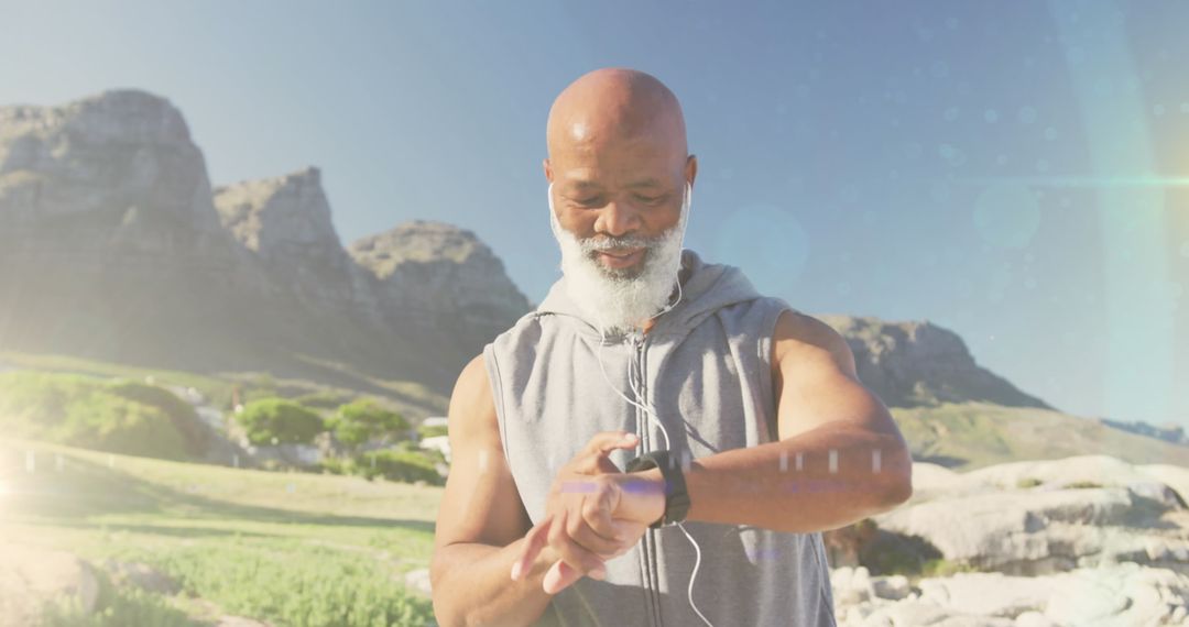 Active Senior Man Outdoors Checking Fitness Tracker