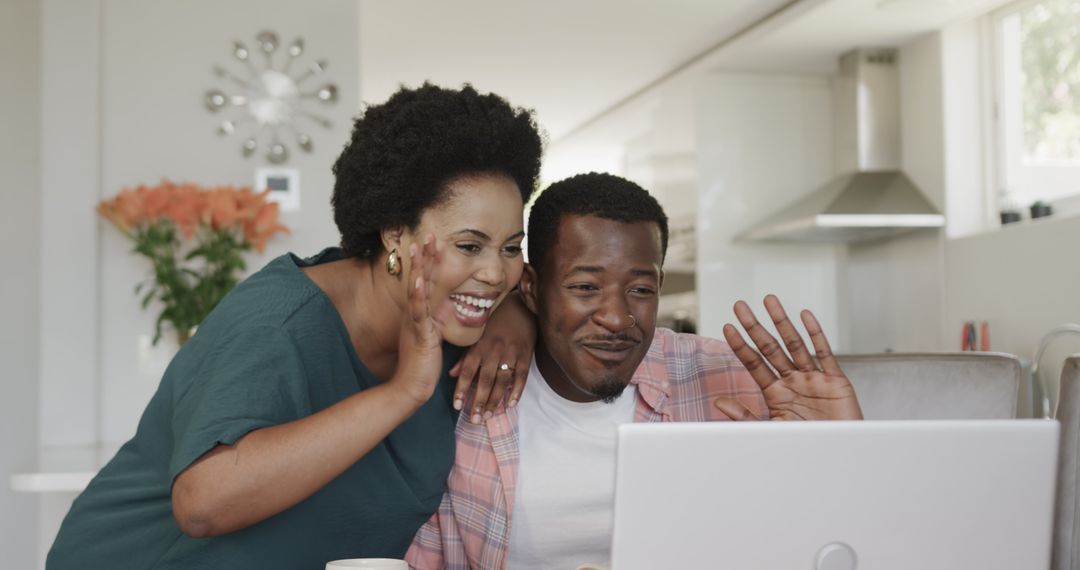 Happy Couple Enjoying Video Call on Laptop in Modern Home