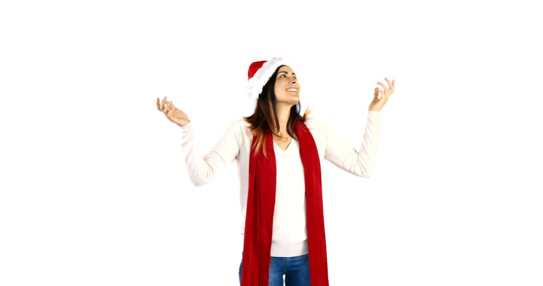 Joyful Woman Celebrating Christmas in Santa Hat and Red Scarf - Free Images, Stock Photos and Pictures on Pikwizard.com