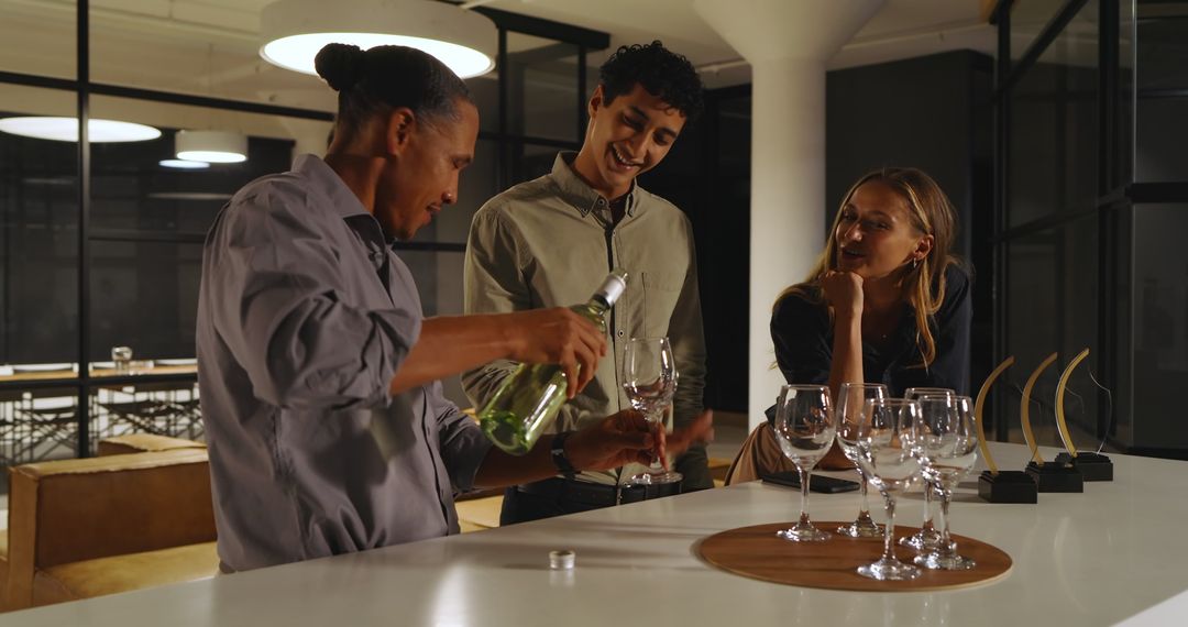 Diverse Team Socializing with Drinks at Office Gathering