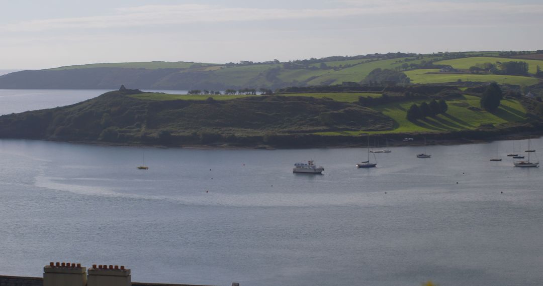 Boats Anchored in Calm Bay with Scenic Hills in Background - Free Images, Stock Photos and Pictures on Pikwizard.com