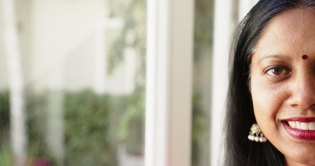 Smiling Indian Woman by Window in Natural Light