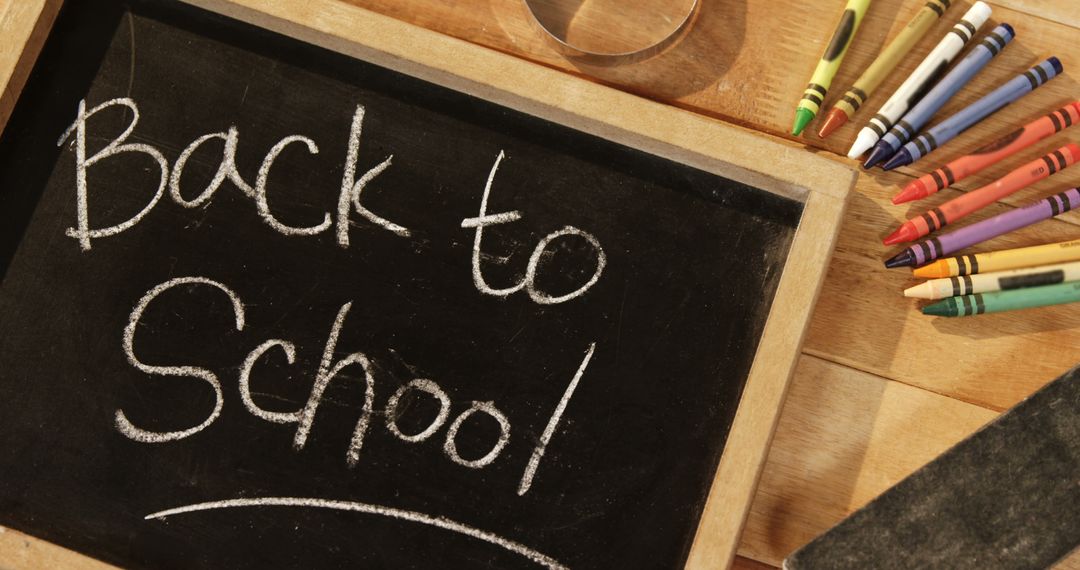 Back to School Chalkboard with Crayons on Desk - Free Images, Stock Photos and Pictures on Pikwizard.com