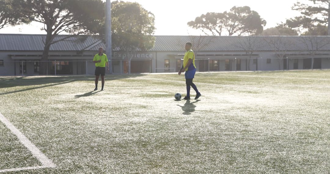 Sunny Soccer Practice with Players Preparing on Field