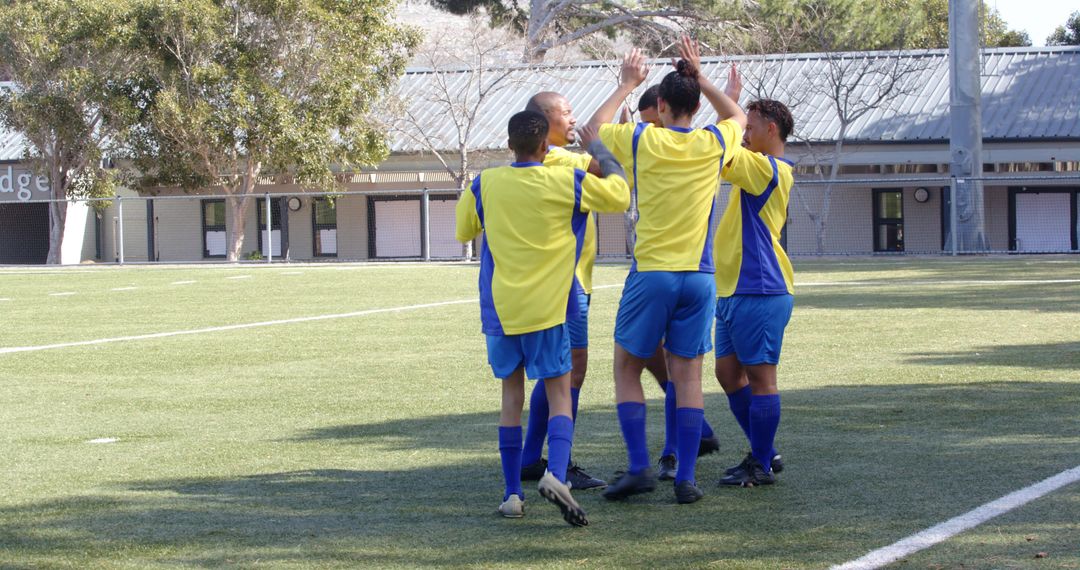 Soccer Team Celebrating Unity on Green Field