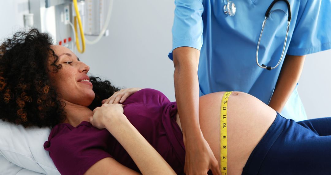A healthcare professional measures the belly of a pregnant African American woman, with copy space - Free Images, Stock Photos and Pictures on Pikwizard.com